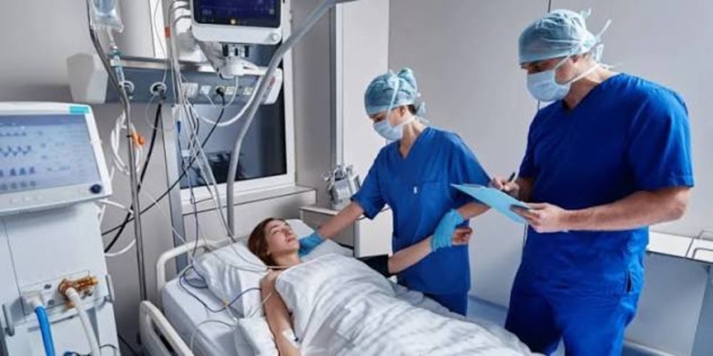 A care team working at an ICU bedside