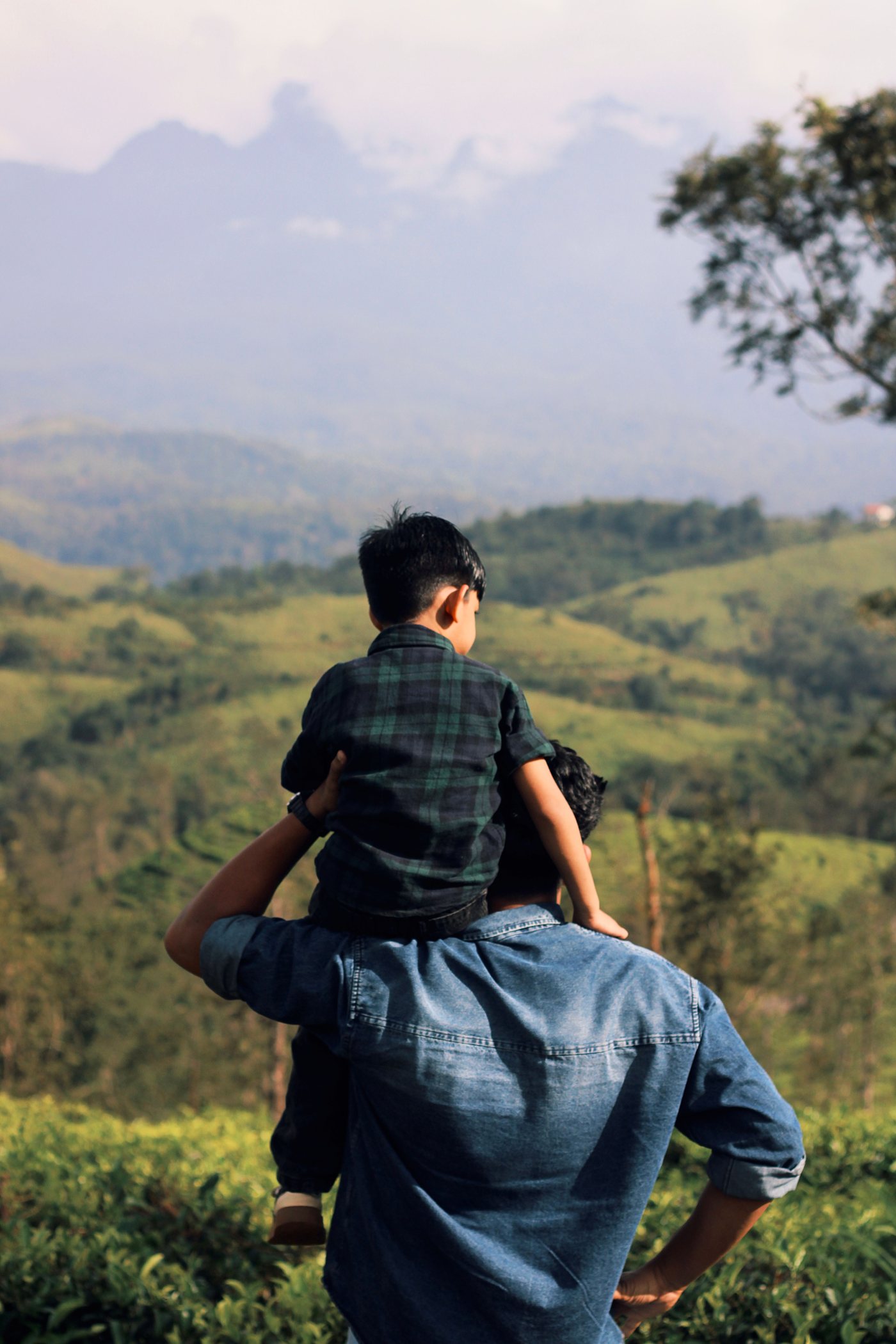 A father carrying his son on his shoulders